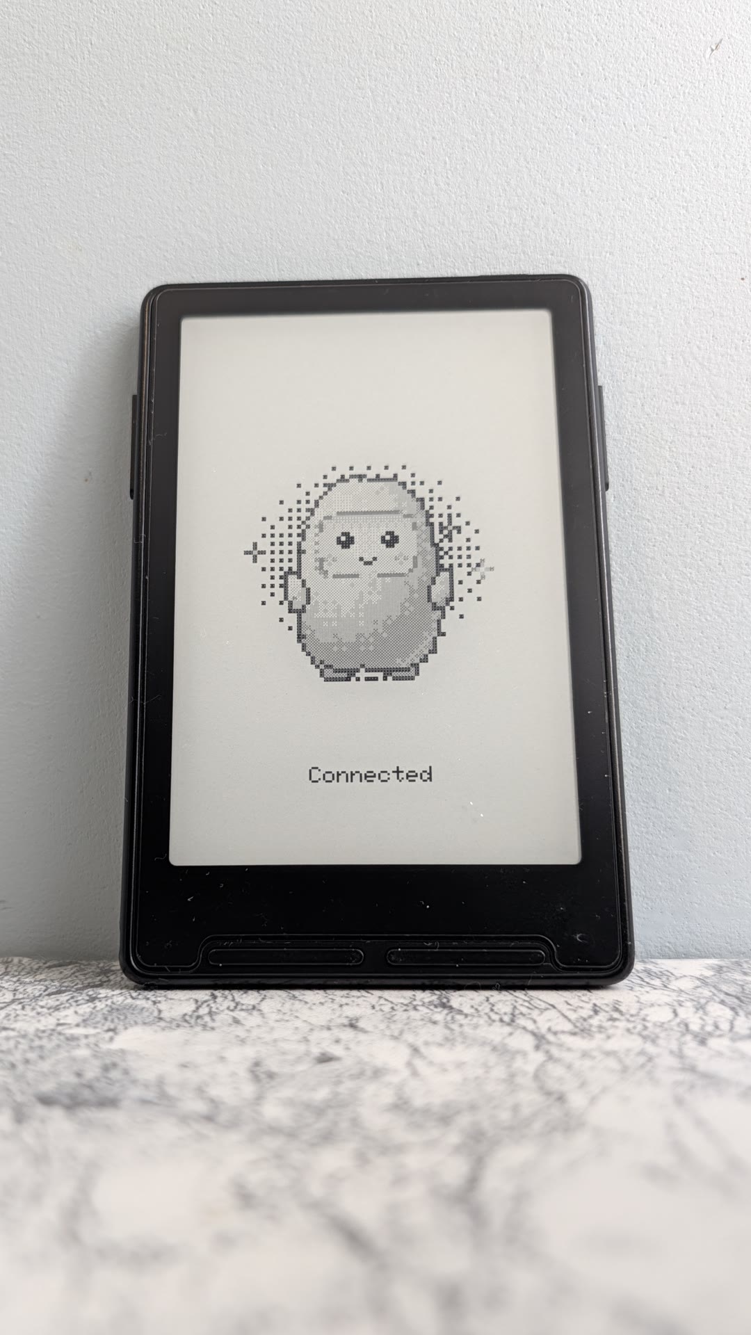 The Xteink X3 e-ink reader showing the Muse mascot and the word Connected